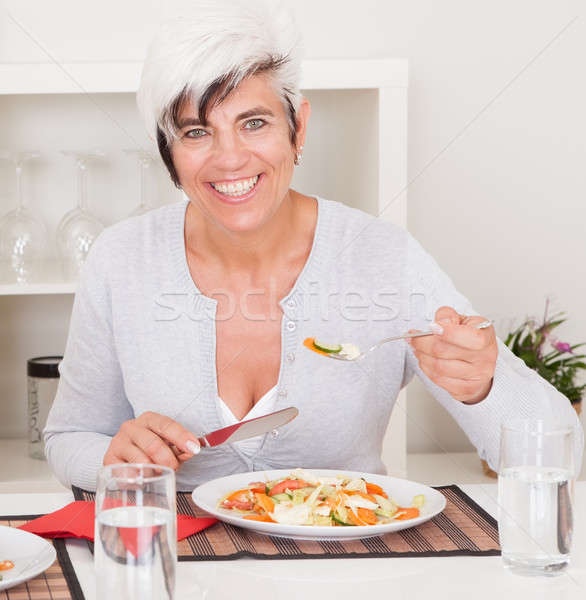 Senior woman eating a meal Stock photo © AndreyPopov