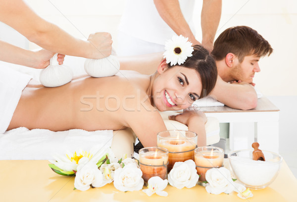 Woman Receiving Massage With Herbal Compress Stamps Stock photo © AndreyPopov