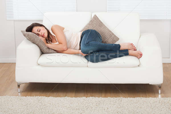 Young Woman Sleeping On Sofa At Home Stock photo © AndreyPopov