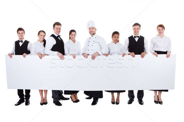 Group of catering staff holding a blank banner Stock photo © AndreyPopov