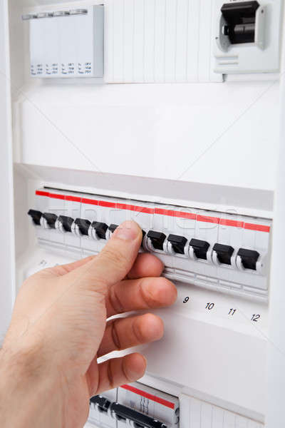 Human Hand On Distribution Board Stock photo © AndreyPopov