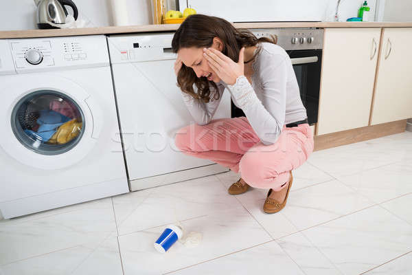 Woman Looking At Yoghurt Fallen On The Floor Stock photo © AndreyPopov