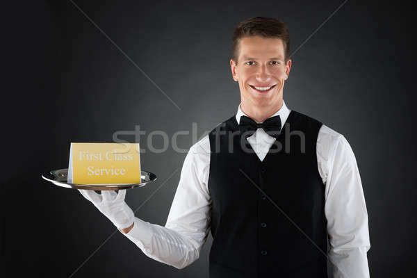 Pierwsza klasa usługi pokładzie młodych szczęśliwy kelner Zdjęcia stock © AndreyPopov