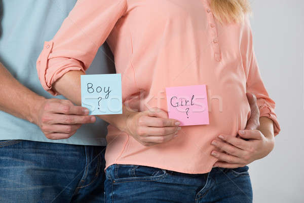 Expecting Couple Holding Paper With Girl And Boy Text Stock photo © AndreyPopov