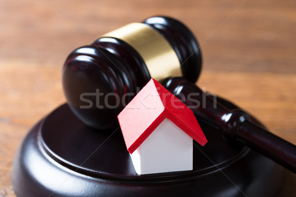 Mallet With House Model On Table In Courtroom Stock photo © AndreyPopov