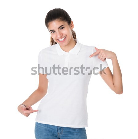 Smiling Young Woman Pointing Towards Blank Tshirt Stock photo © AndreyPopov