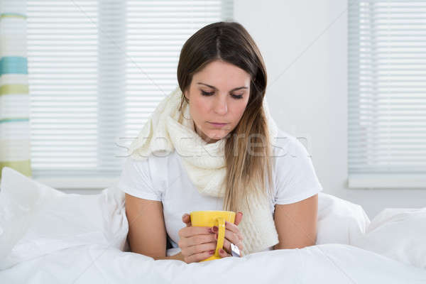 Stock photo: Young Woman In Bed With Cup