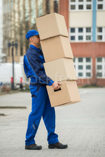 Delivery Man Balancing Stack Of Boxes Stock photo © AndreyPopov