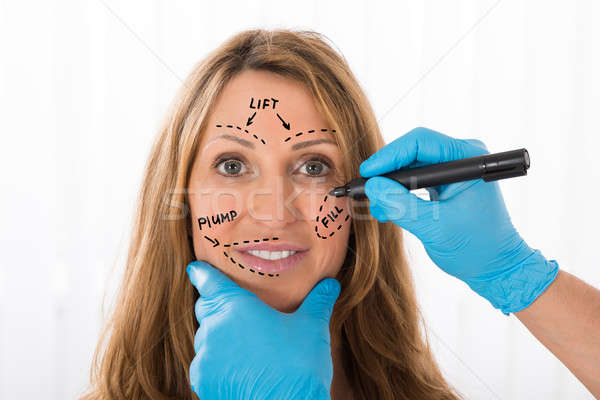Woman With Perforation Lines Marked On Face Stock photo © AndreyPopov