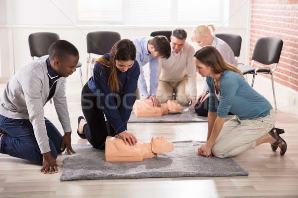 Students Practicing CPR Chest Compression On Dummy Stock photo © AndreyPopov