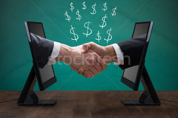 Two Men Shaking Hands From Computer Screen Stock photo © AndreyPopov