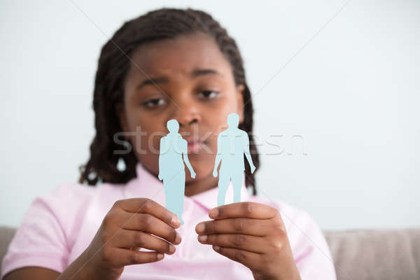 Divorce Concept. Sad Girl Holding Parents Paper Figures In Hands Stock photo © AndreyPopov