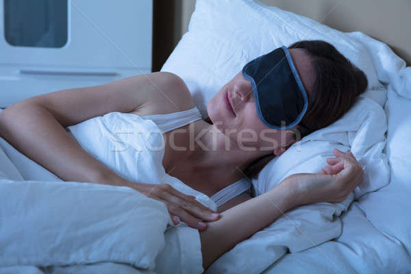 Woman Sleeping In Bed With Eye Mask Stock photo © AndreyPopov