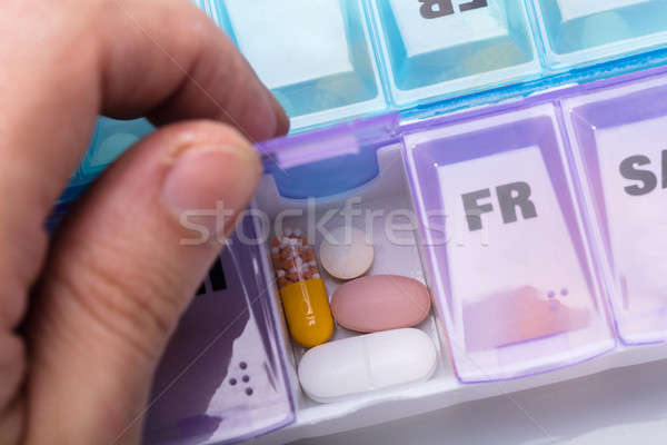 Person Opening Thursday Pills Box Container Stock photo © AndreyPopov
