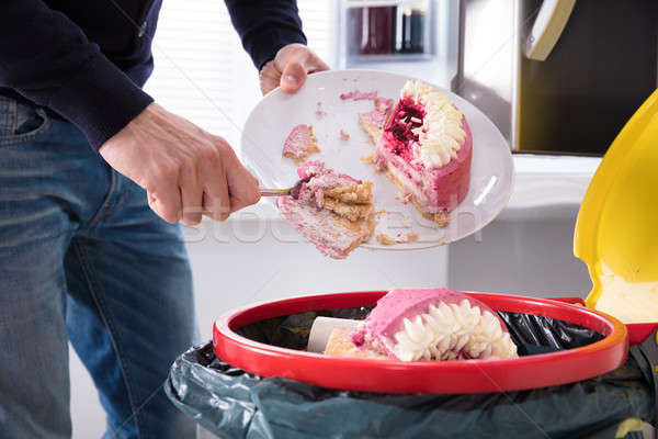 Person Throwing Cake In Trash Bin Stock photo © AndreyPopov