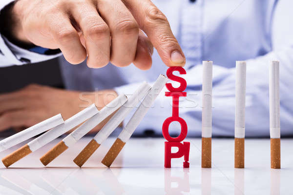 Person Protecting Falling Cigarettes With Stop Word Stock photo © AndreyPopov