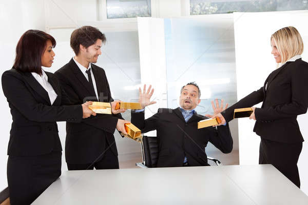 Businessman receiving gold bars Stock photo © AndreyPopov