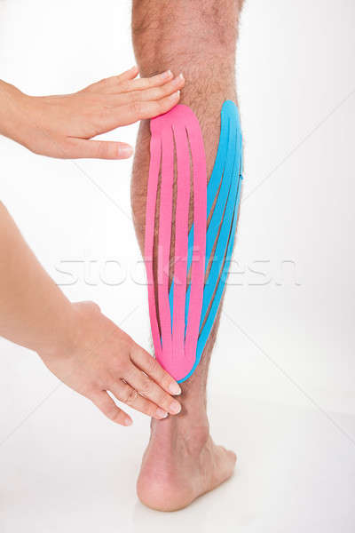 Person Applying Physio Tape On Calf Stock photo © AndreyPopov