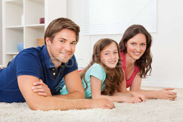 Family Lying Together On Rug At Home Stock photo © AndreyPopov