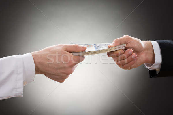 Businessman Giving Money To Doctor Stock photo © AndreyPopov