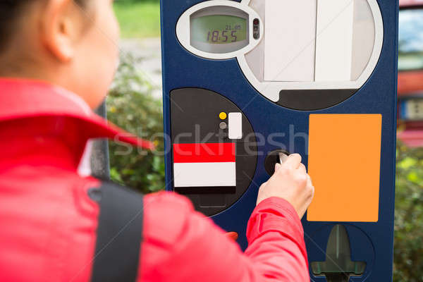 Woman Inserting Coin In Parking Meter Stock photo © AndreyPopov