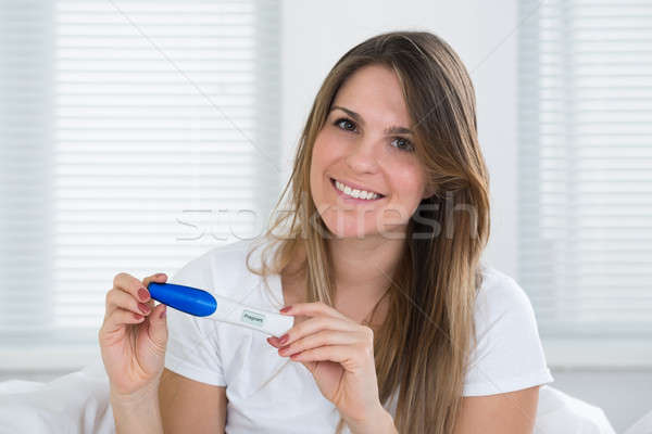 Stock photo: Young Woman With Pregnancy Test Kit