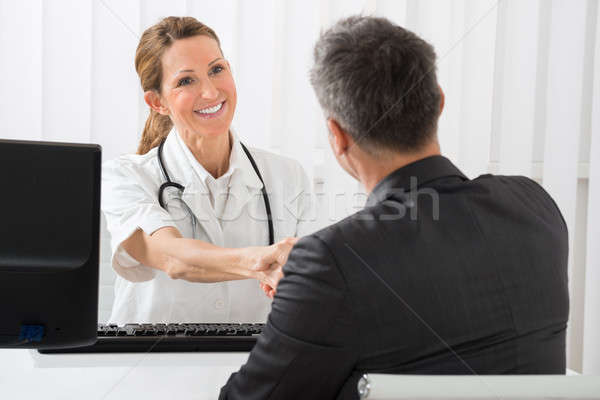 Doctor Shaking Hands With Businessman Stock photo © AndreyPopov