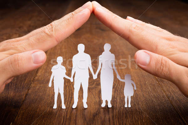 Stock photo: Person Hand Protecting Family Papercut