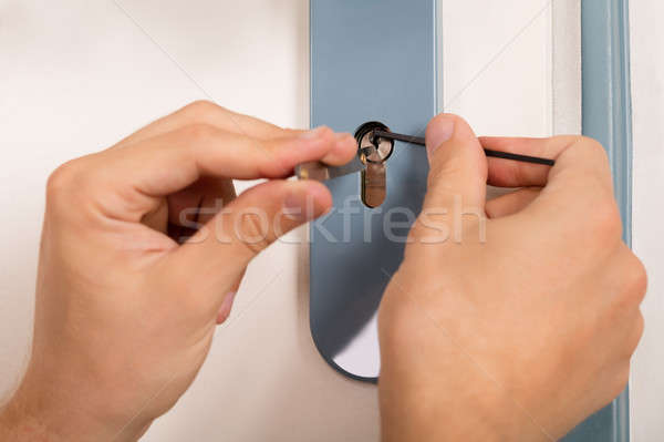 Lockpicker Opening Door Lock Stock photo © AndreyPopov