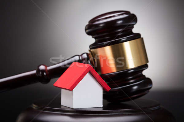 Gavel And House Model On Sounding Block Stock photo © AndreyPopov