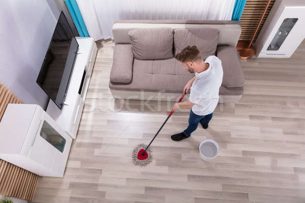 Stock photo: Man Cleaning Floor With Mop