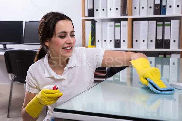 Woman Cleaning The Glass Office Desk With Rag Stock photo © AndreyPopov