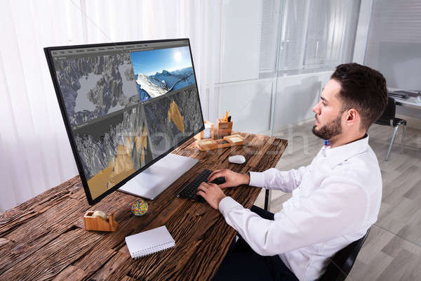 Man Editing 3D Landscape On Computer Stock photo © AndreyPopov
