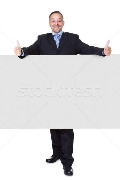 Happy Businessman Holding Blank Billboard Stock photo © AndreyPopov