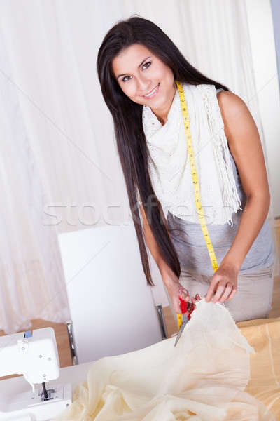 Beautiful woman cutting fabric Stock photo © AndreyPopov