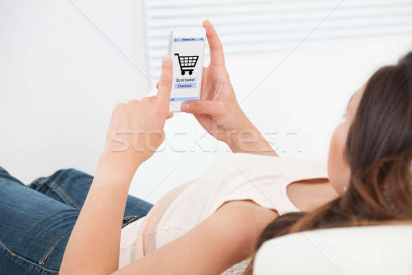 Woman Shopping Online On Mobile Phone At Home Stock photo © AndreyPopov