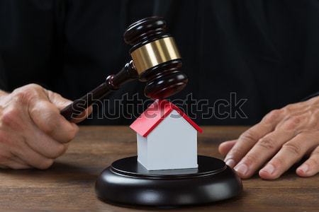 Judge Holding Gavel On House At Desk Stock photo © AndreyPopov