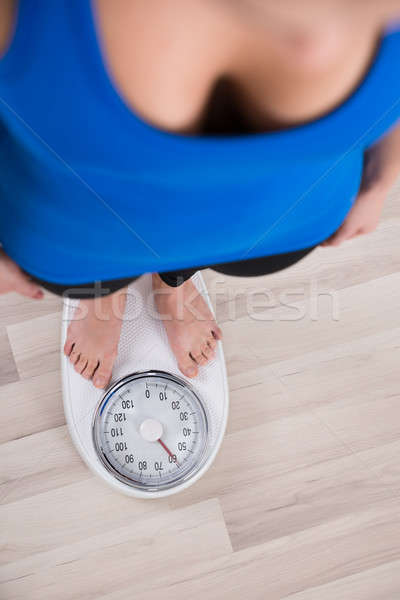 Woman Measuring Weight On Weighing Scale Stock photo © AndreyPopov