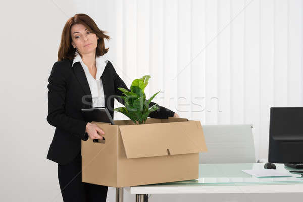 Sad Businesswoman Packing Her Belongings In Box Stock photo © AndreyPopov