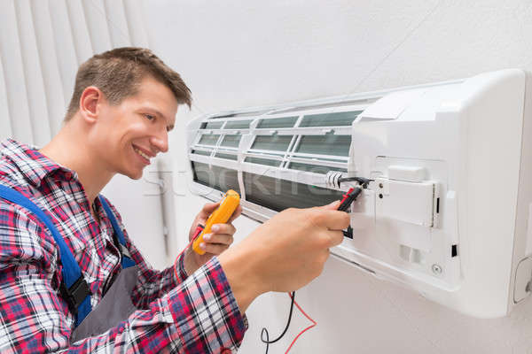 Technician Examining Air Conditioner Stock photo © AndreyPopov