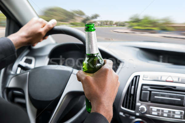 Businessman Holding Beer While Driving Car Stock photo © AndreyPopov