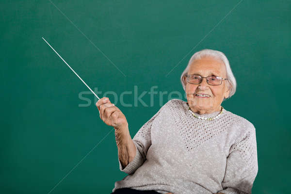 Happy Female Teacher In Classroom Stock photo © AndreyPopov