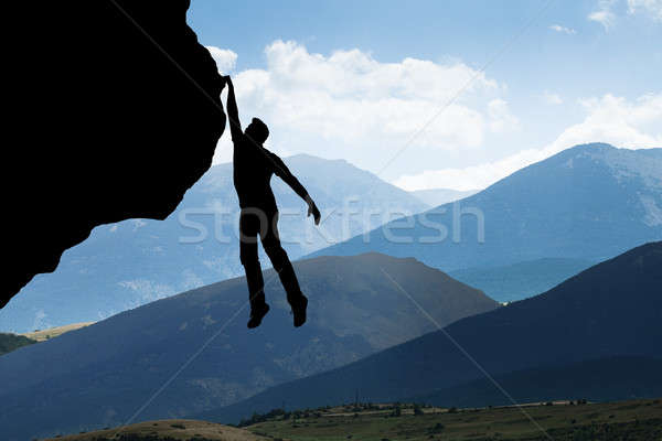 Man Climbing On Rocky Mountain Stock photo © AndreyPopov