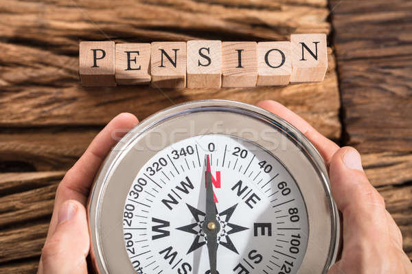 Hand Holding Compass On Pension Block Stock photo © AndreyPopov