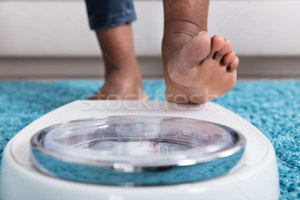 Human Foot Stepping On Weighing Scale Stock photo © AndreyPopov