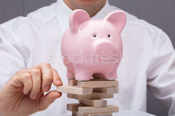 Businessperson's Hand Removing Wooden Block Stock photo © AndreyPopov