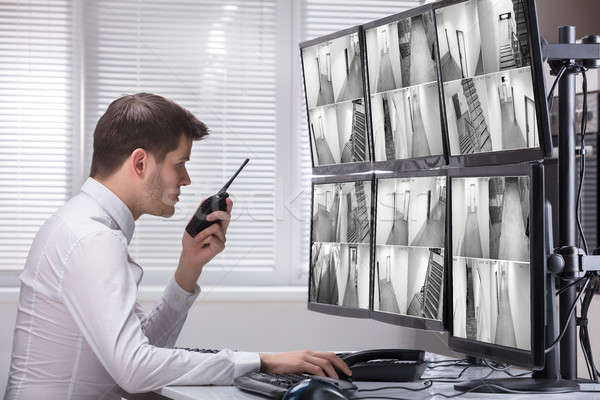 Stock photo: Security Guard Monitoring CCTV Footage