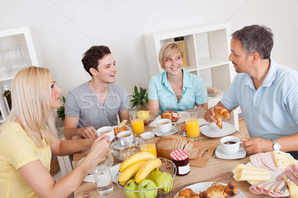 Stock photo: Happy family enjoying breakfast