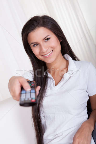 Smiling woman with a remote control Stock photo © AndreyPopov