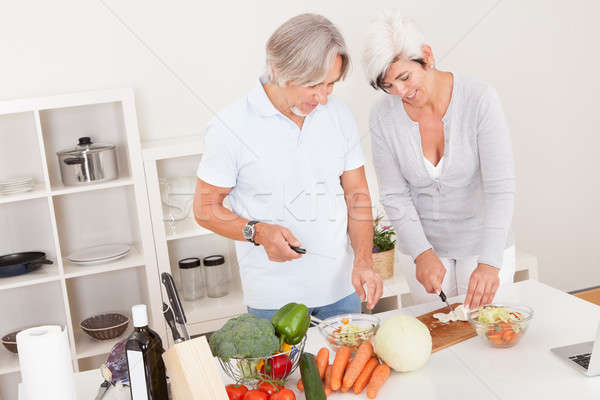 Middle-aged couple preparing a meal Stock photo © AndreyPopov